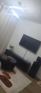 a living room with a table and a ceiling at Lace Luxe Homes in Tatu City