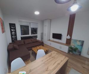 a living room with a couch and a table at Apartman Symbol in Tuzla +10 photos