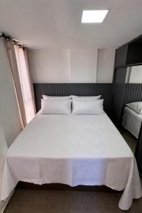 a bedroom with a large bed with white sheets at Flat PREMIUM em Manaíra - Sun Beach in João Pessoa +15 photos