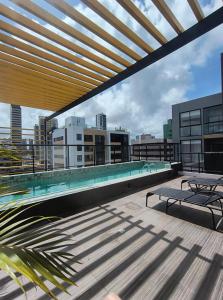 a swimming pool on the roof of a building at Flat PREMIUM em Manaíra - Sun Beach in João Pessoa