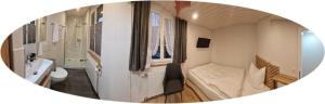 a small room with a bedroom and a bathroom at Mirchel Pintli, Zimmer 2, Hotel & Restaurant in Zäziwil