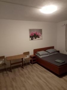 a bedroom with a bed and a desk and a table at Ubytovna Nika in Přerov