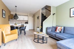 a living room with a couch and a table at Appartement De Bosrand, Resort Amelander Kaap in Hollum