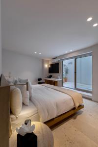 a bedroom with a large bed with a large window at Capitalia Reforma Chapultepec in Mexico City