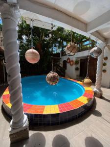 a swimming pool with a colorful tile around it at Recanto do caja in Porto De Galinhas