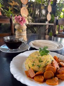 a table with plates of food and a cup of coffee at Recanto do caja in Porto De Galinhas