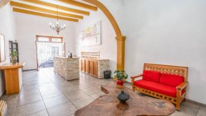 a living room with a red couch and a table at Cinco de Mayo Hotel in Querétaro