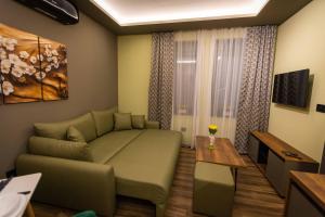 a living room with a couch and a table at Apartman ALPINA Bogatic in Bogatić