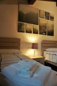 a bedroom with two beds and a table with a lamp at Villa Castaldi Firenze vicina al centro in Florence
