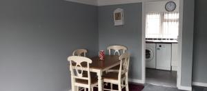 a dining room with a table and two chairs at Lilypad in Devizes