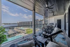 a balcony with chairs and a view of the water at Family Tides Condo for 8 in Osage Beach