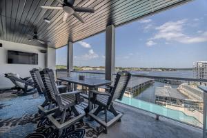 a patio with a table and chairs on a balcony at Family Tides Condo for 8 in Osage Beach