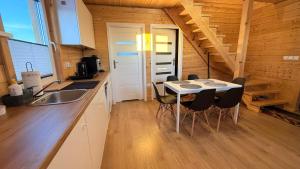 a kitchen with a table and chairs in a room at Cud Miód Mazury in Bogaczewo +2 photos