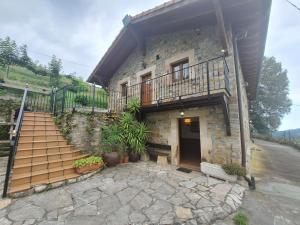 a stone house with stairs and plants in front of it at La Casa del Acebal (Solorzano - Cantabria) in Solórzano