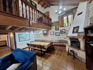 a living room with a table and a fireplace at La Casa del Acebal (Solorzano - Cantabria) in Solórzano