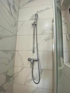 a shower in a bathroom with white marble walls at Marija Block St Julian's Apartments in Is-Swieqi +28 photos
