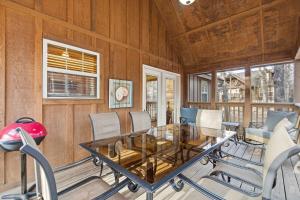 a dining room with a glass table and chairs at Blue Sky Lodge For 4 in Branson West