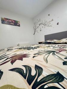 a bedroom with a bed with a design on it at Le Paradis d'Ayli in Aywaille