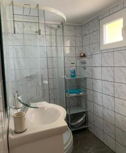a bathroom with a sink and a shower and a toilet at Sweet Cosy Apartment in Matulji +27 photos