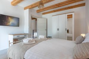 a white bedroom with a large bed with towels on it at Villa Gino in Pazin +22 photos