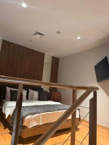 a bedroom with a bed and a flat screen tv at סוויטת דופלקס על הים בבת ים in Bat Yam