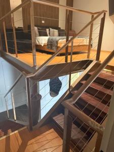 a metal bunk bed in a room with a staircase at סוויטת דופלקס על הים בבת ים in Bat Yam