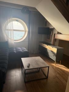 a living room with a couch and a table at חדר על הים בבת ים in Bat Yam