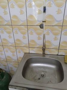 a sink in a kitchen with a faucet at La casa in Kribi +17 photos