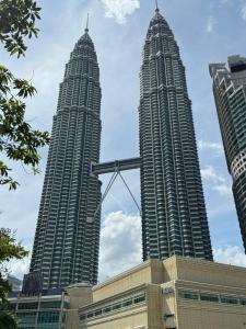two tall buildings with a crane in front of them at XING LUN KLCC Platinum Suites in Kuala Lumpur