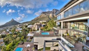an aerial view of a building with mountains in the background at Sea Star Rocks Boutique Hotel in Cape Town