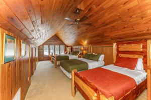 a bedroom with two beds in a wooden cabin at Grace Place in Watersmeet