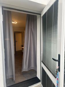 a sliding glass door with a view of a hallway at Byt v podzámčí in Litomyšl