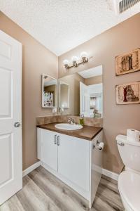 a bathroom with a sink and a toilet at Cozy Vacation Home in Calgary +14 photos