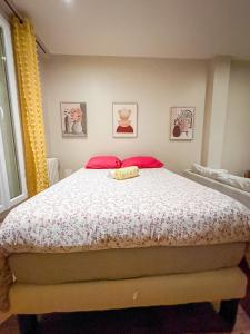 a bedroom with a large bed with red pillows at Centre ville - Houilles in Houilles