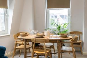 a wooden table in a room with chairs around it at 90A Tower Road in Newquay +14 photos