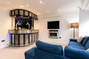 a living room with a blue couch and a fireplace at 90A Tower Road in Newquay