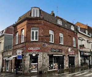 an old brick building on a city street at Studio Opale in Lille