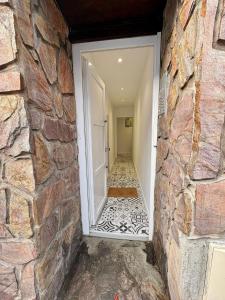 a stone wall with a door leading to a hallway at Studio Opale in Lille
