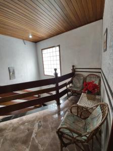 a room with two chairs and a window at Hotel Flor da Vila Mariana in São Paulo