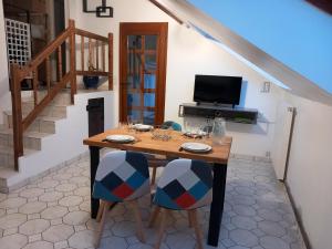 a dining room with a wooden table and chairs at Gite Le Savart in Chartèves