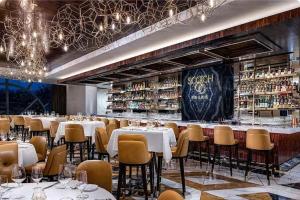 a restaurant with tables and chairs and a bar at Palms Place in Las Vegas
