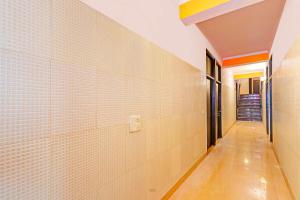 an empty hallway with white tiled walls and a corridor at Collection O Rewari Central Railway Junction in Rewāri +40 photos