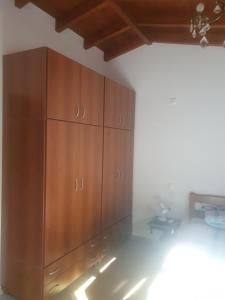 a large wooden cabinet in the corner of a room at Villa Macky Cottage in Kato Almiri