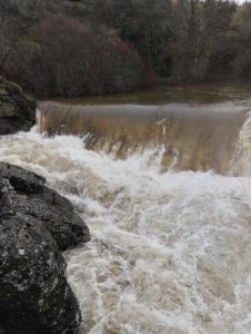 a river with white rapids on top of it at El rincón del Vadillo in La Velilla