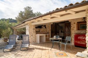 a patio with a table and chairs in front of a house at Villa Roba degli Ulivi in Agrigento