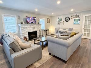 a living room with two couches and a fireplace at Addison House License# 004-2025 in Niagara-on-the-Lake