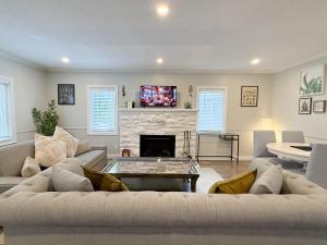 a living room with a couch and a fireplace at Addison House License# 004-2025 in Niagara-on-the-Lake