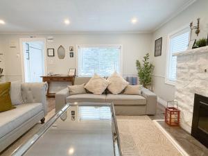 a living room with a couch and a fireplace at Addison House License# 004-2025 in Niagara-on-the-Lake