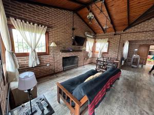 a living room with a couch and a fireplace at Valle Verde in Villa Giardino