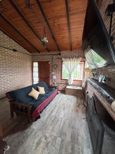 a large room with a bed and a brick wall at Valle Verde in Villa Giardino